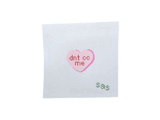 Cross-stitched heart with 'dnt cc me' text on a white background