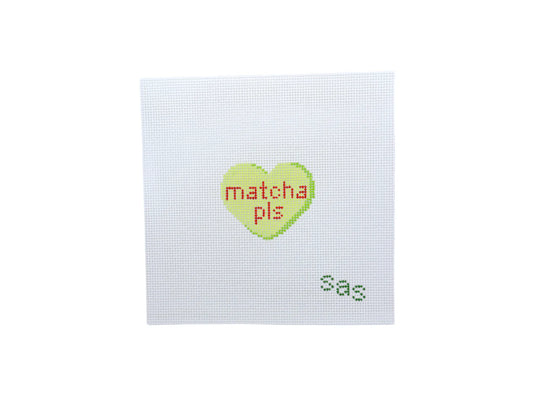 Cross-stitched heart with 'matcha pls' text on a white background