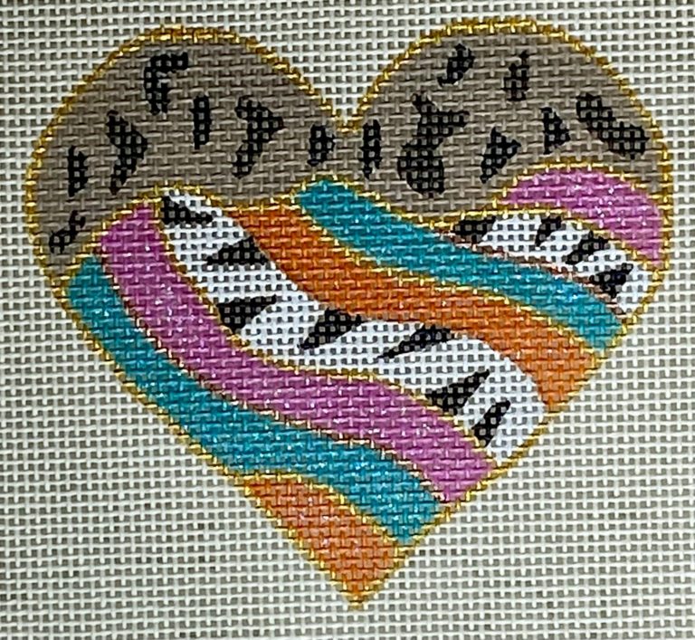 Heart-shaped design with musical notes and a piano, embroidered on fabric.