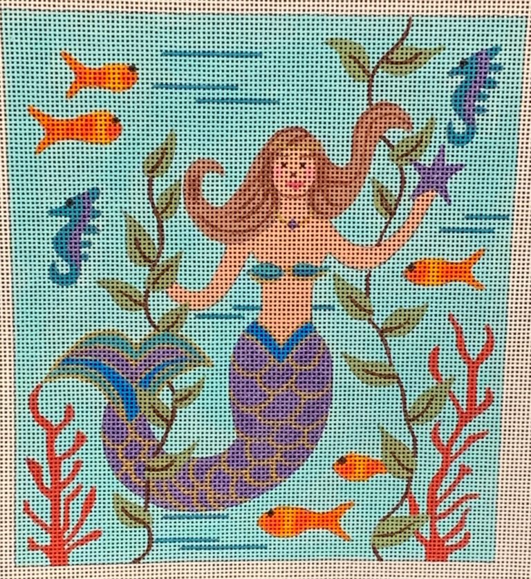 Colorful needlepoint canvas with a mermaid and sea creatures on a blue background