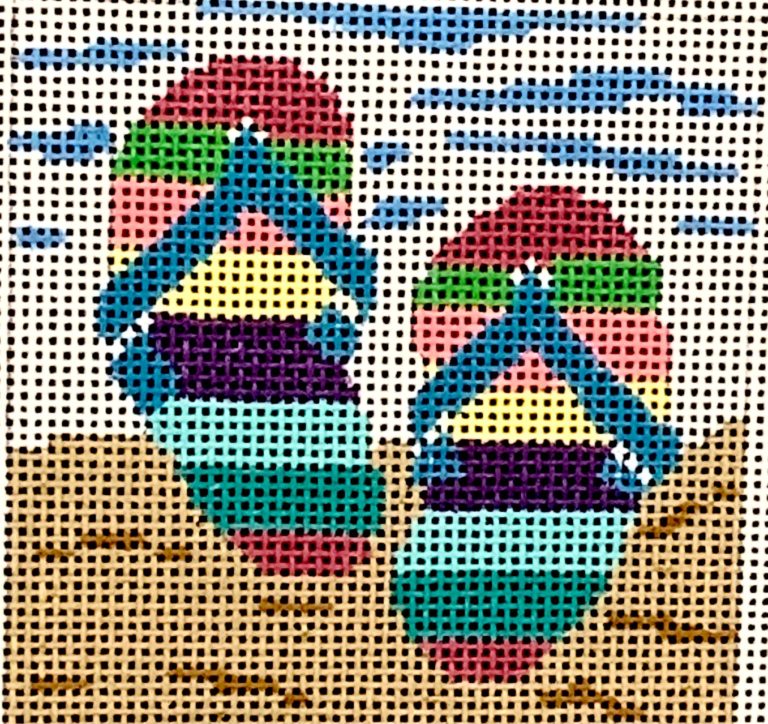 Colorful rooster design on a cross-stitch canvas
