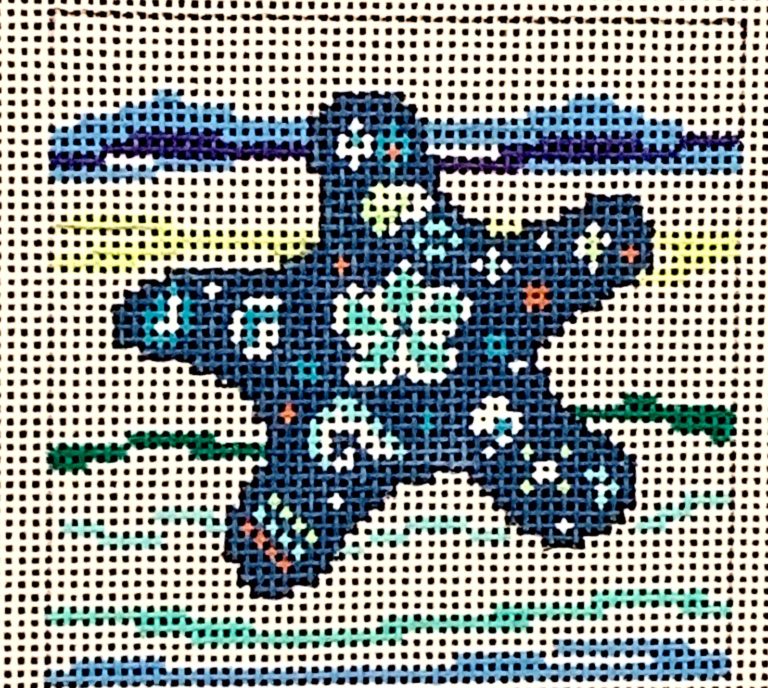 Cross-stitched design of a blue star on a white background