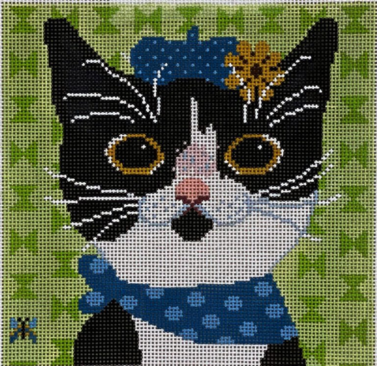 Cat with a blue bandana and flower on a green cross-stitch pattern