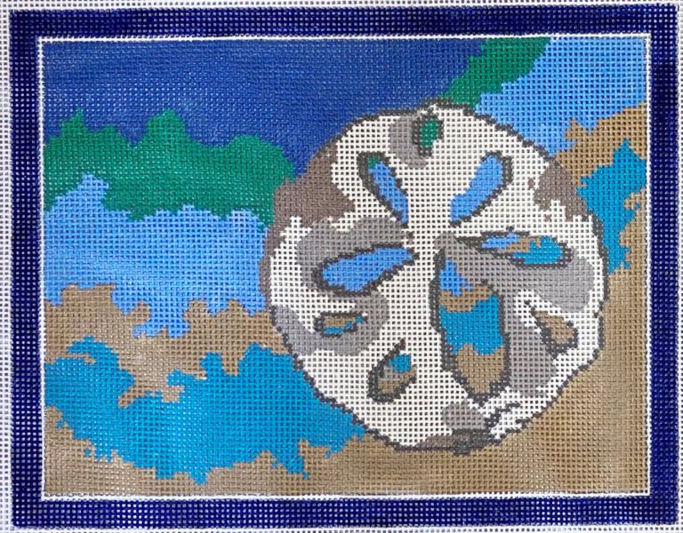 Decorative needlepoint canvas with a wheel design on a blue border