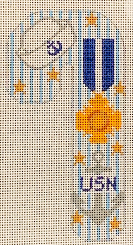 Cross-stitched design of a flag with 'USN' on a white background