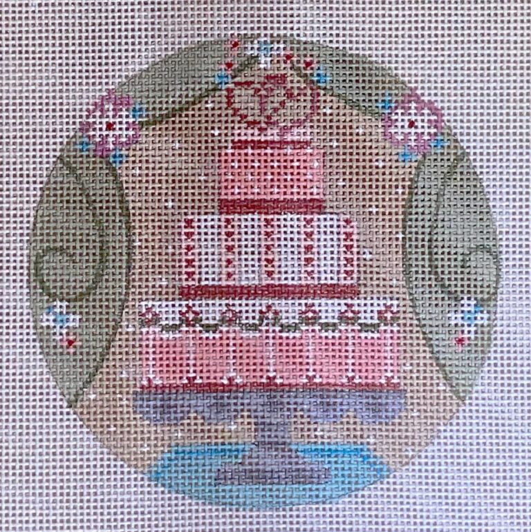 Cross-stitched pink cake on a gray background