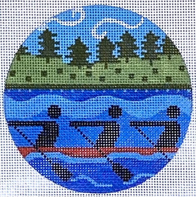 Circular needlepoint canvas with a landscape design featuring trees, mountains, and a bridge.