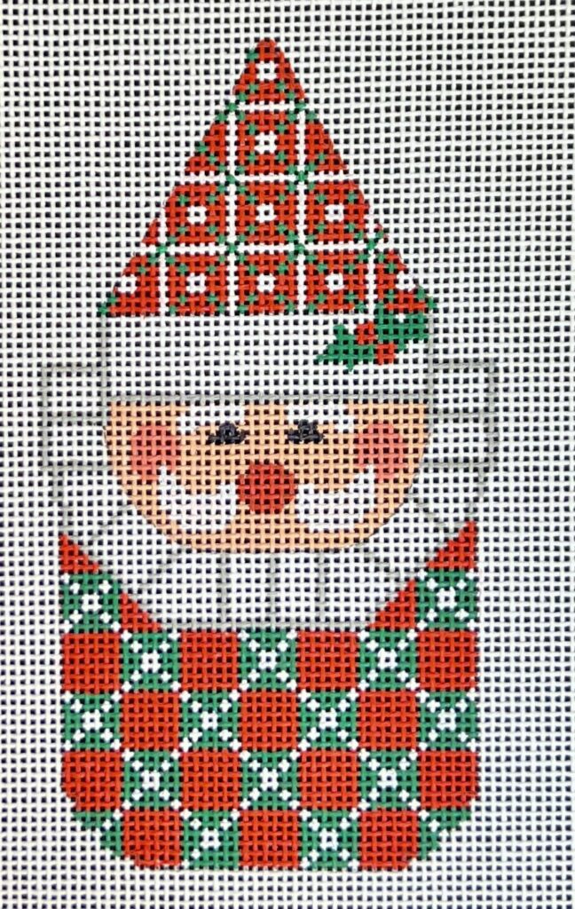 Cross-stitched design of a bear wearing a Christmas tree hat and patterned sweater.