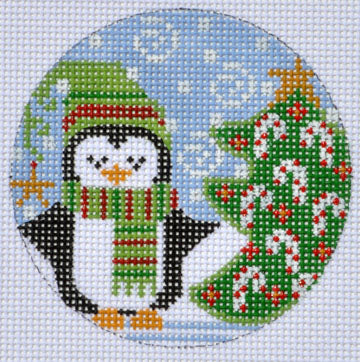 Cross-stitched penguin with a Christmas tree and ornaments on a white background
