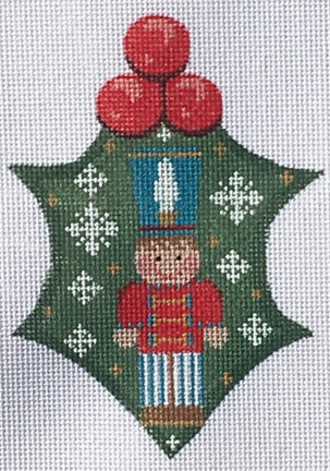 Decorative Christmas ornament with a nutcracker design on a green background