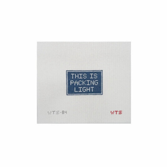 Textile with 'THIS IS PACKING LIGHT' embroidery on a white background