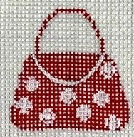 Red handbag with white polka dots and floral patterns on a white background