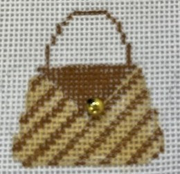 Cross-stitched design of a brown handbag with a yellow button on a white background