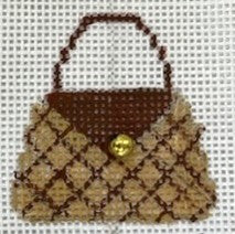 Miniature handbag with brown handle and patterned body on a white background
