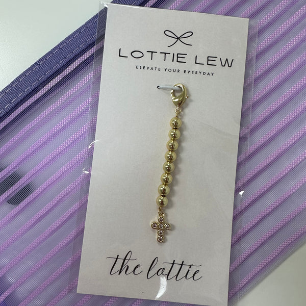 Gold beaded charm on a Lottie Lew card with a purple striped background