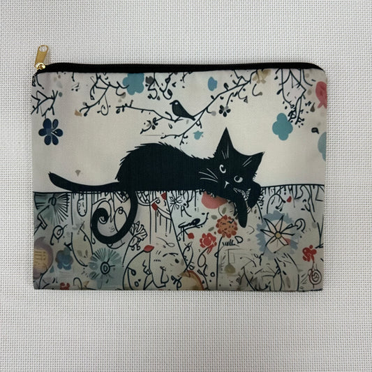 Pouch with a black cat design on a floral and branch patterned background