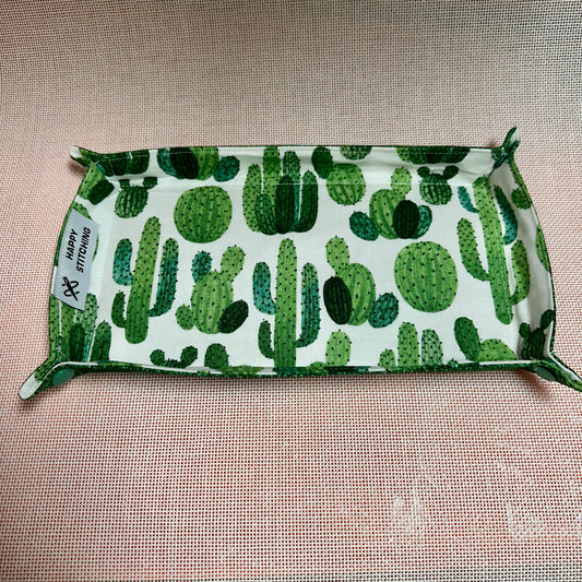 Fabric with green cactus pattern on a beige background