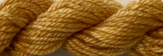 A close-up of thick twisted yarn or rope in a warm golden tan color, filling the frame.