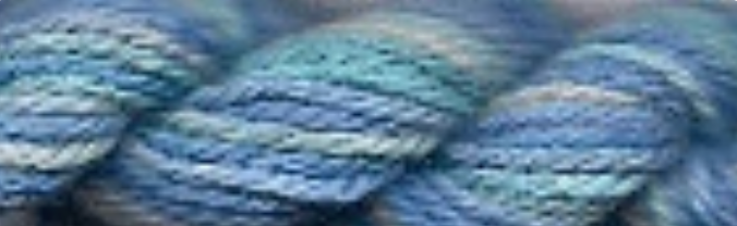 A close-up of variegated yarn with blended blue, teal, and light gray-green strands.