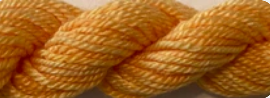 A close-up of a twisted yarn or thread skein in a warm mustard yellow color, filling the entire frame.
